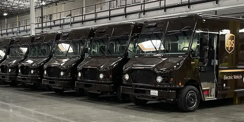 A line of parked brown UPS trucks